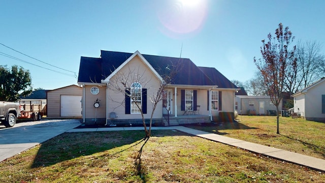 view of front of house with an outbuilding, a front yard, and a garage