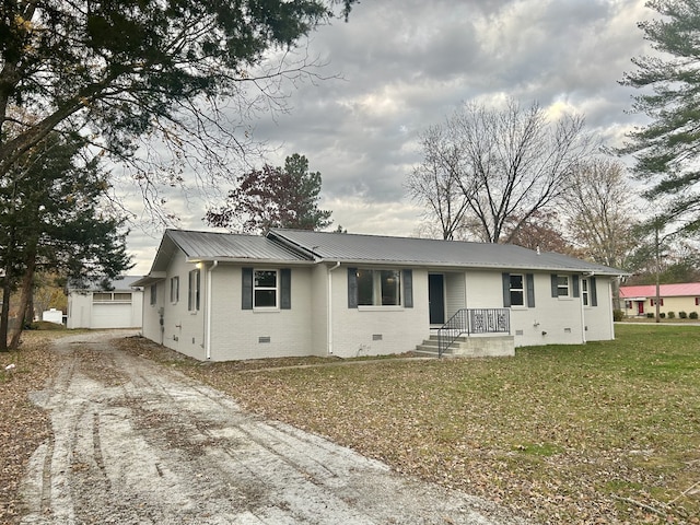 single story home with a garage, an outdoor structure, and a front yard