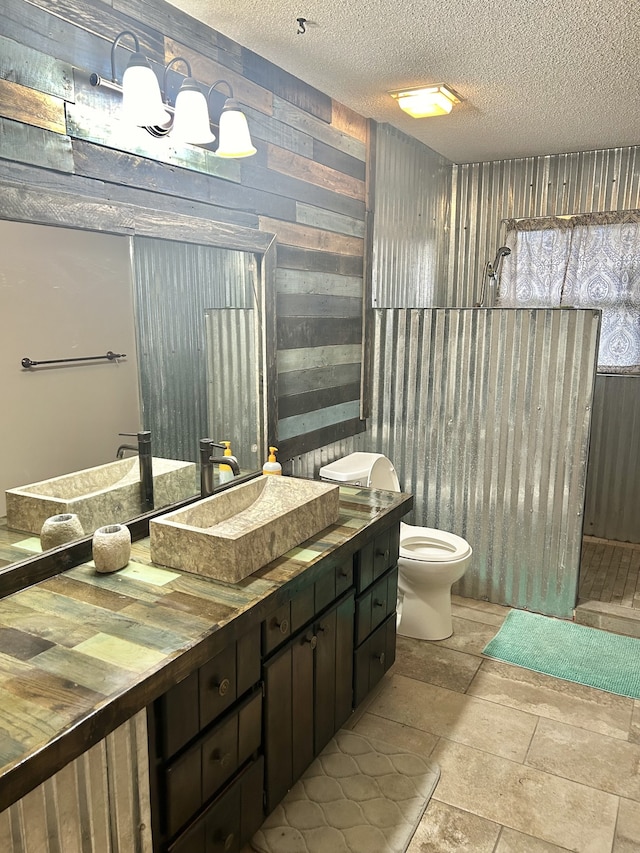 bathroom featuring vanity, toilet, and a textured ceiling