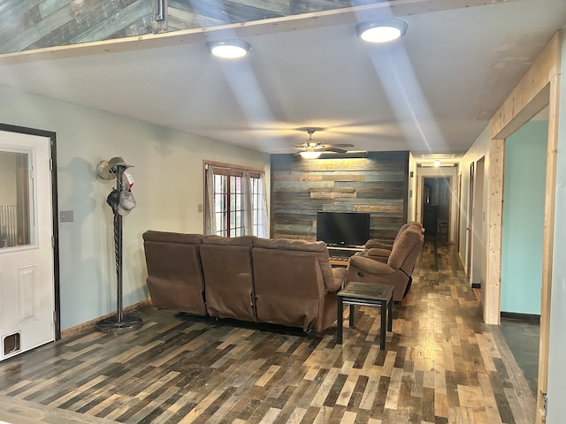 living room with lofted ceiling, ceiling fan, and dark wood-type flooring