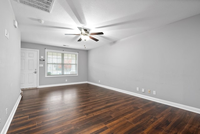 empty room with dark hardwood / wood-style floors, ceiling fan, and a textured ceiling