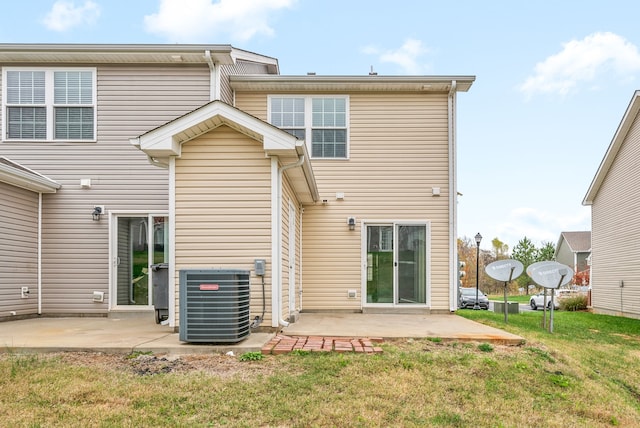 back of house with a patio, central AC unit, and a lawn