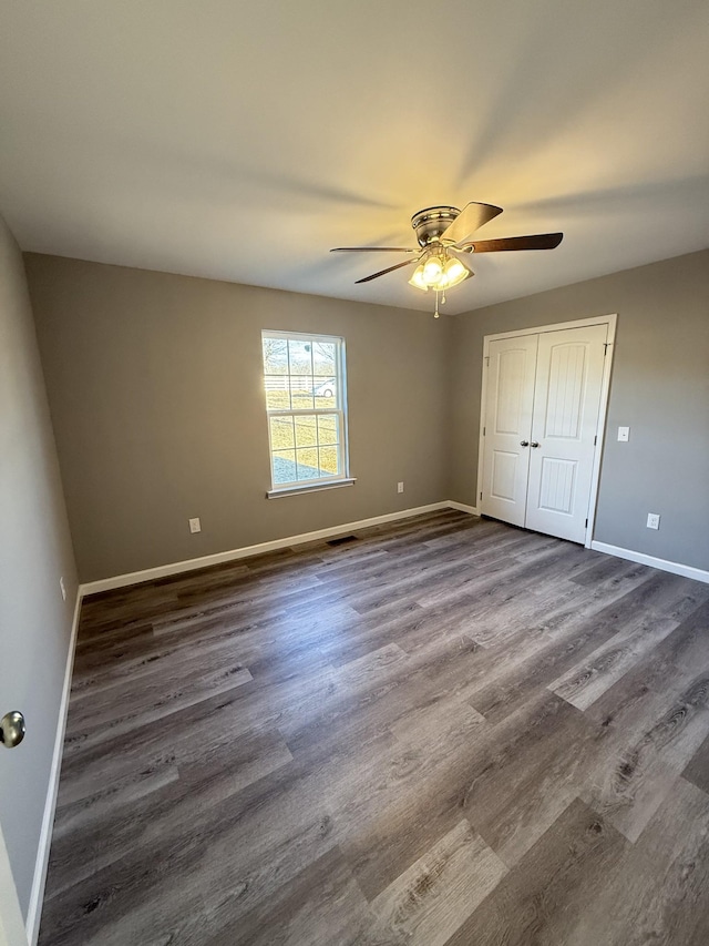 1260 Hutchins Rd, Mc Minnville, TN 37110 - unfurnished bedroom featuring dark wood-type flooring, ceiling fan, and a closet