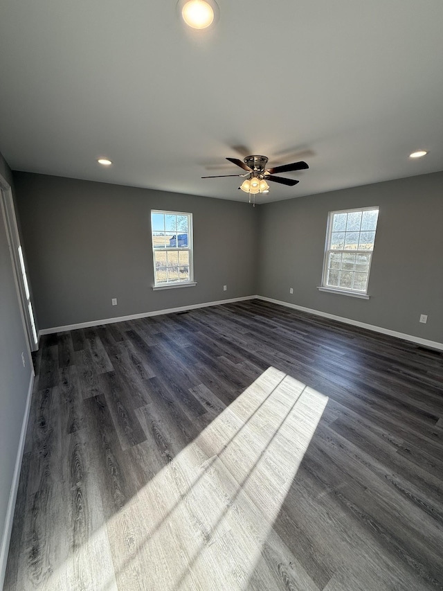 1260 Hutchins Rd, Mc Minnville, TN 37110 - empty room featuring ceiling fan, a healthy amount of sunlight, and dark hardwood / wood-style flooring