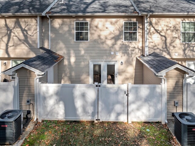 rear view of property featuring central AC