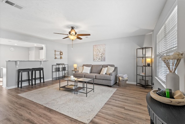 living room featuring dark hardwood / wood-style flooring and ceiling fan