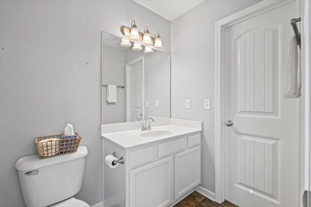 bathroom with toilet and vanity