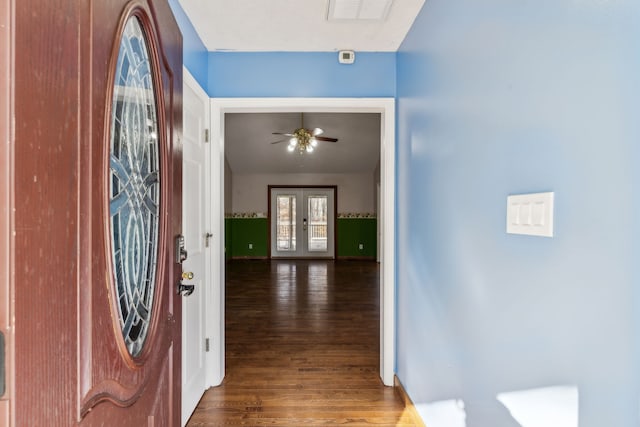 foyer entrance with french doors, dark hardwood / wood-style flooring, and ceiling fan