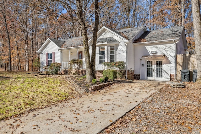 view of front of house with covered porch and french doors