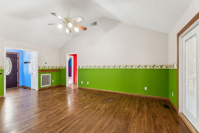 unfurnished living room with vaulted ceiling, ceiling fan, and dark wood-type flooring