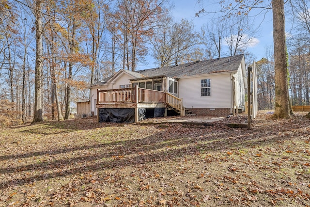 exterior space with a sunroom and a wooden deck