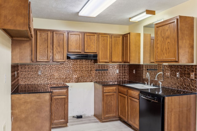 kitchen with sink, light wood-type flooring, a textured ceiling, black dishwasher, and tasteful backsplash