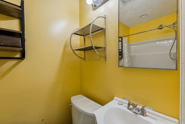 bathroom with sink, toilet, and walk in shower