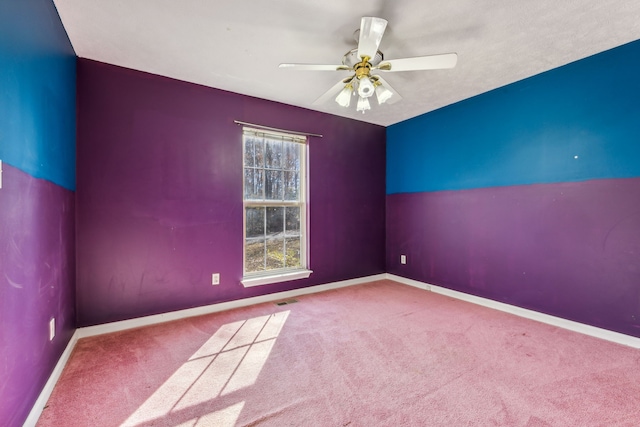 spare room with carpet flooring and ceiling fan