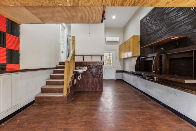 kitchen featuring dark hardwood / wood-style floors, an AC wall unit, and sink