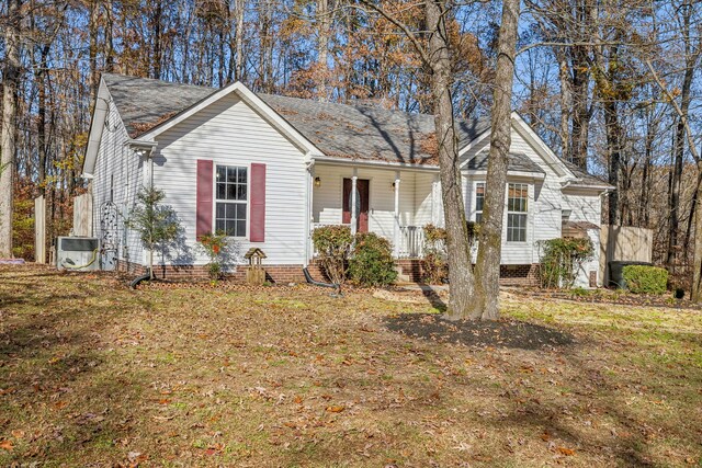 ranch-style home featuring covered porch and a front yard