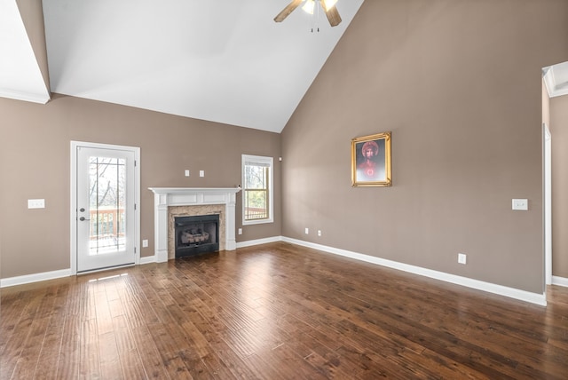 unfurnished living room with ceiling fan, a fireplace, high vaulted ceiling, and dark hardwood / wood-style floors