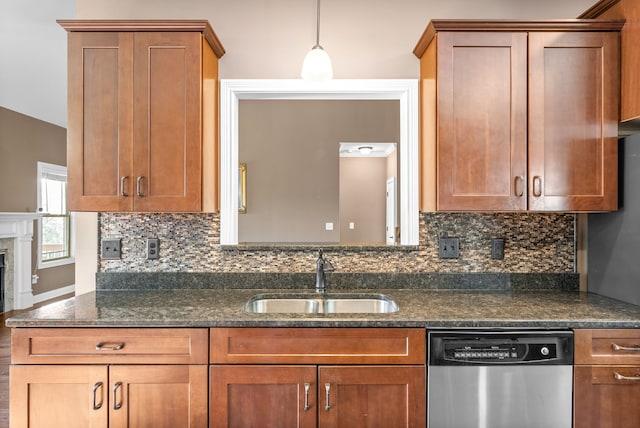 kitchen featuring decorative backsplash, dark stone counters, sink, pendant lighting, and dishwasher