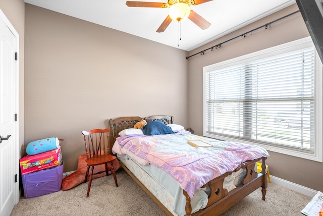 bedroom with light colored carpet and ceiling fan