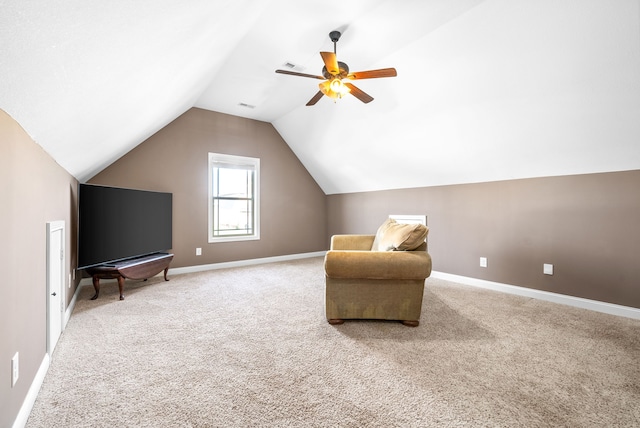 sitting room with ceiling fan, lofted ceiling, and carpet floors