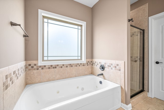 bathroom featuring separate shower and tub