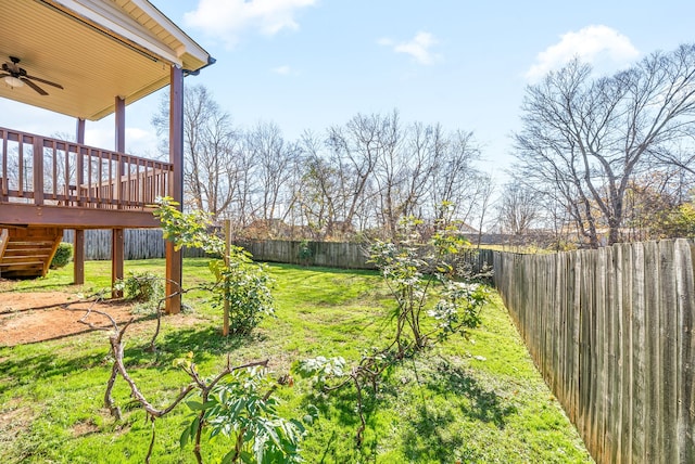 view of yard featuring ceiling fan and a wooden deck