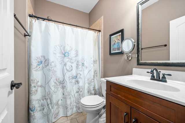 bathroom featuring toilet, vanity, tile patterned floors, and walk in shower