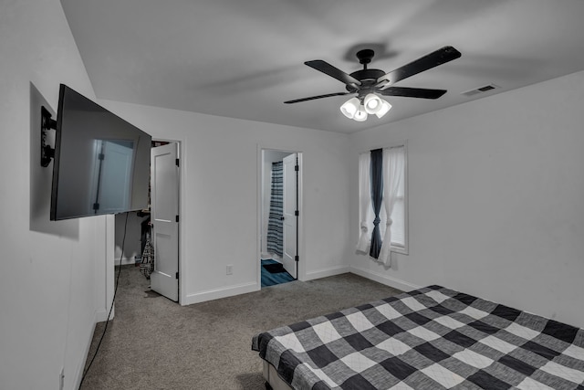 carpeted bedroom with ceiling fan and ensuite bath