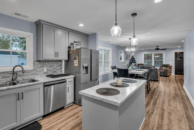 kitchen with ceiling fan, light hardwood / wood-style flooring, sink, and appliances with stainless steel finishes