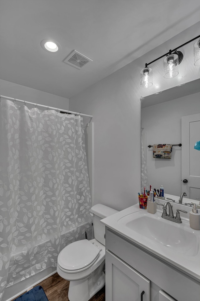 bathroom featuring hardwood / wood-style floors, vanity, and toilet