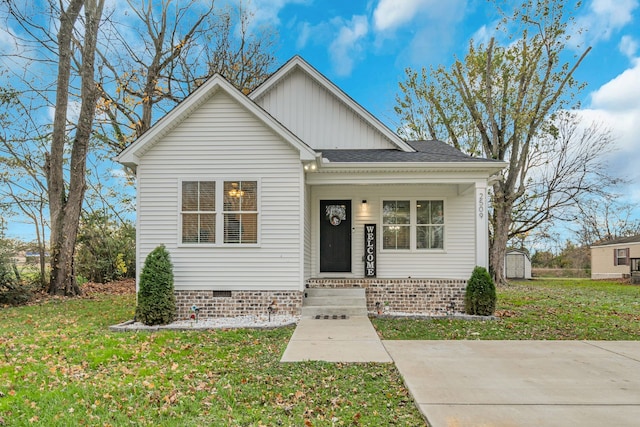 view of front of house with a front lawn and a shed