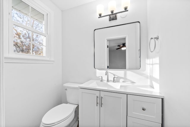 bathroom with vanity, ceiling fan, and toilet