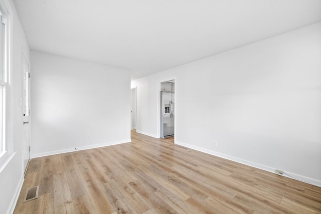 spare room featuring light hardwood / wood-style floors