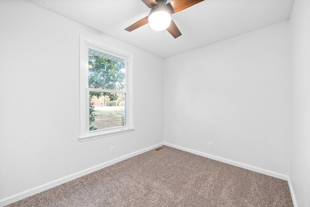 carpeted spare room featuring ceiling fan