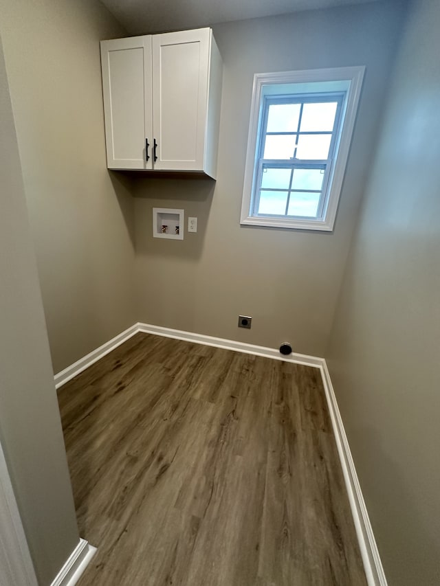 laundry area with cabinets, hookup for a washing machine, hookup for an electric dryer, and hardwood / wood-style floors