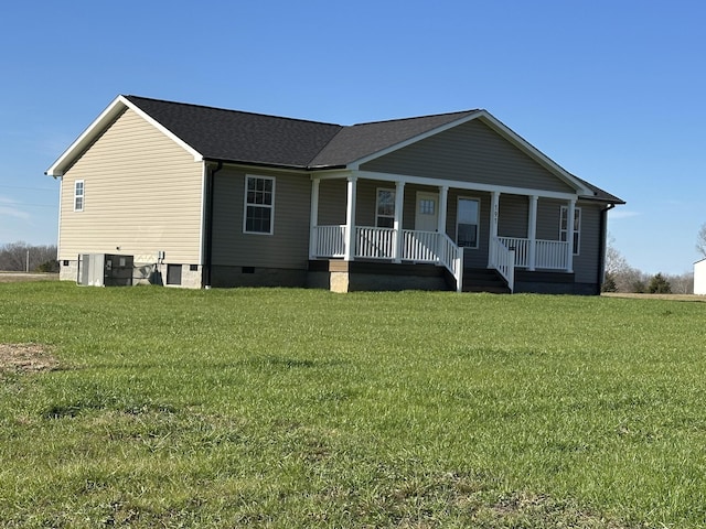 view of front facade with covered porch, central air condition unit, and a front lawn