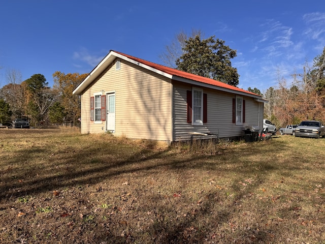 view of side of property with a yard