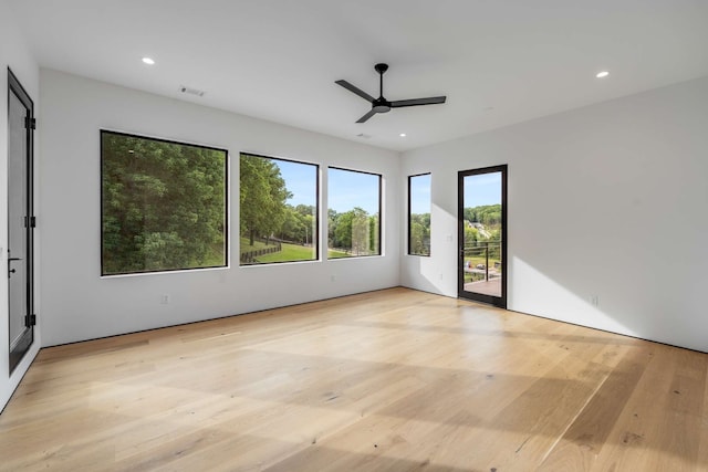 unfurnished room with light wood-type flooring and ceiling fan