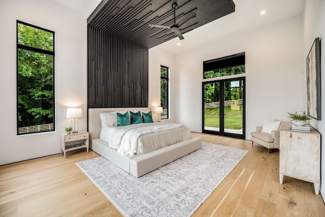 bedroom with light hardwood / wood-style floors and french doors