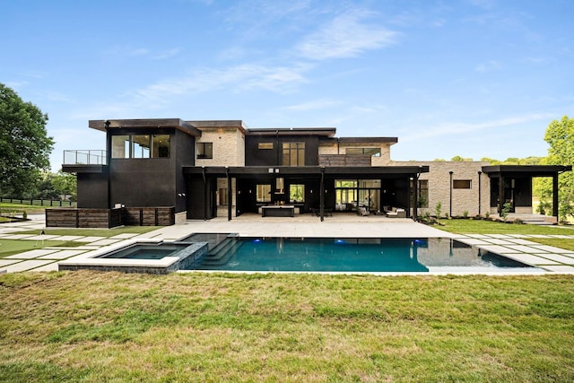 back of house featuring a yard, a balcony, a patio area, and a pool with hot tub