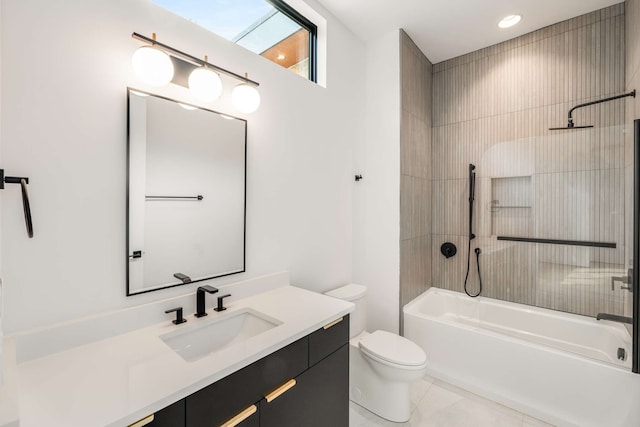 full bathroom featuring tile patterned floors, vanity, tiled shower / bath combo, and toilet