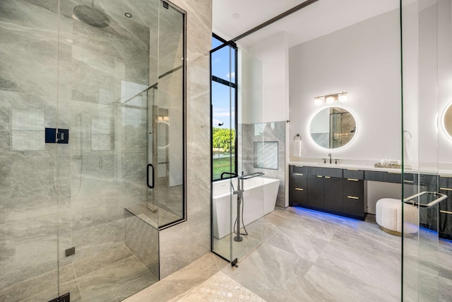 bathroom with plus walk in shower, vanity, and tile walls