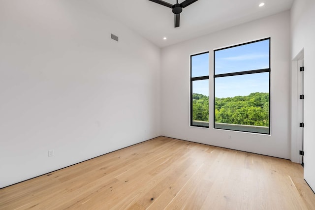 unfurnished room with ceiling fan and light wood-type flooring