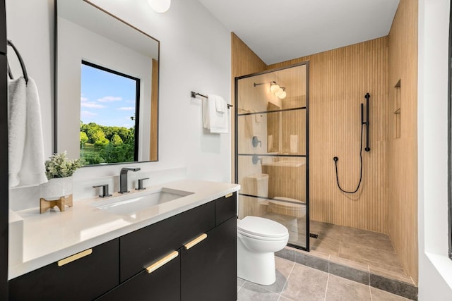 bathroom featuring tile patterned flooring, toilet, vanity, and walk in shower