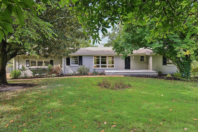 ranch-style home with a patio and a front yard