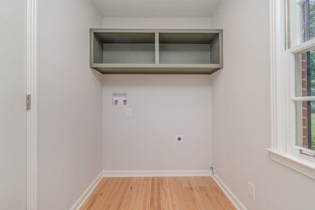 washroom with washer hookup, hookup for an electric dryer, and hardwood / wood-style floors