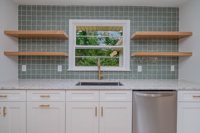 kitchen featuring sink, dishwasher, backsplash, light stone counters, and white cabinets