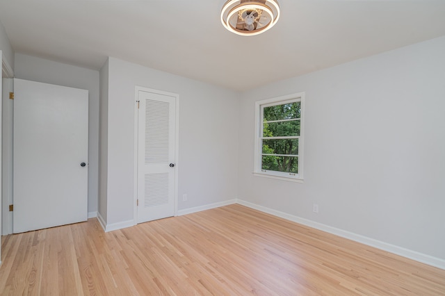 unfurnished room with light wood-type flooring