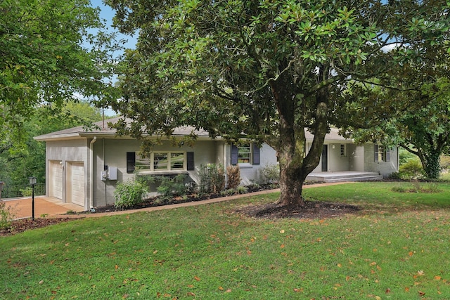 view of front of property with a garage and a front lawn