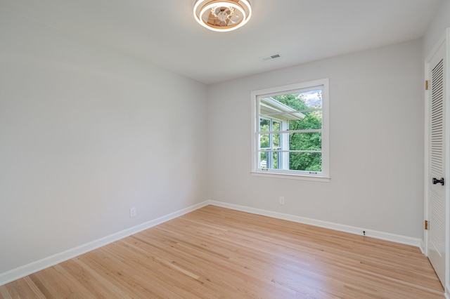 empty room with light hardwood / wood-style flooring